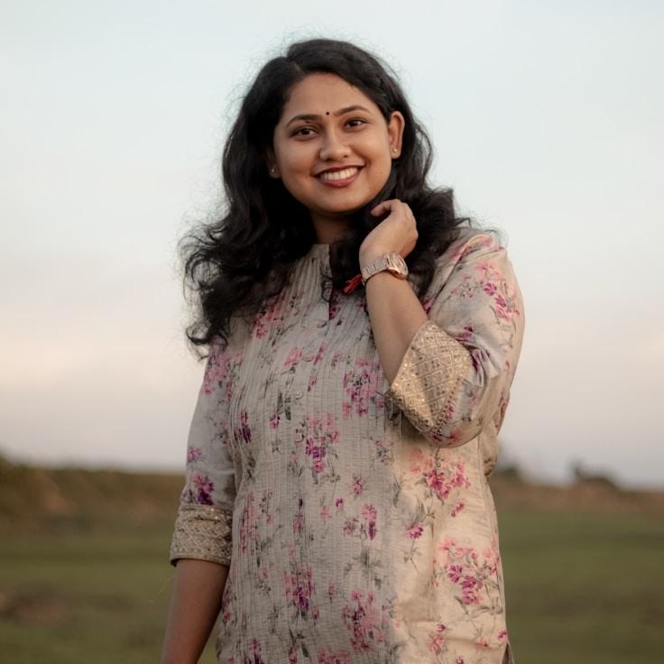 Kaveri Mehta, Lead Design Curator at Quiet Origin Path Way, reviewing corporate floral arrangements